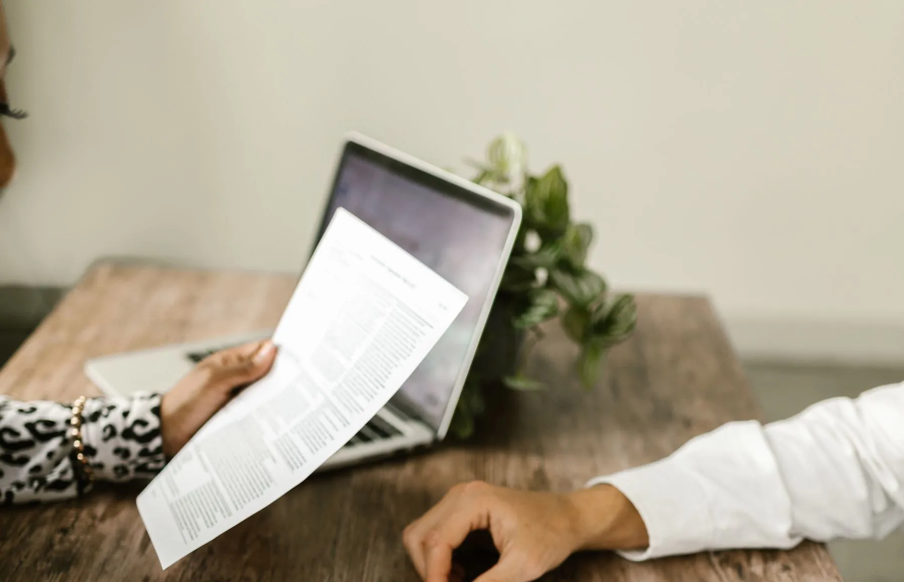 Two people reviewing business documents together at a table